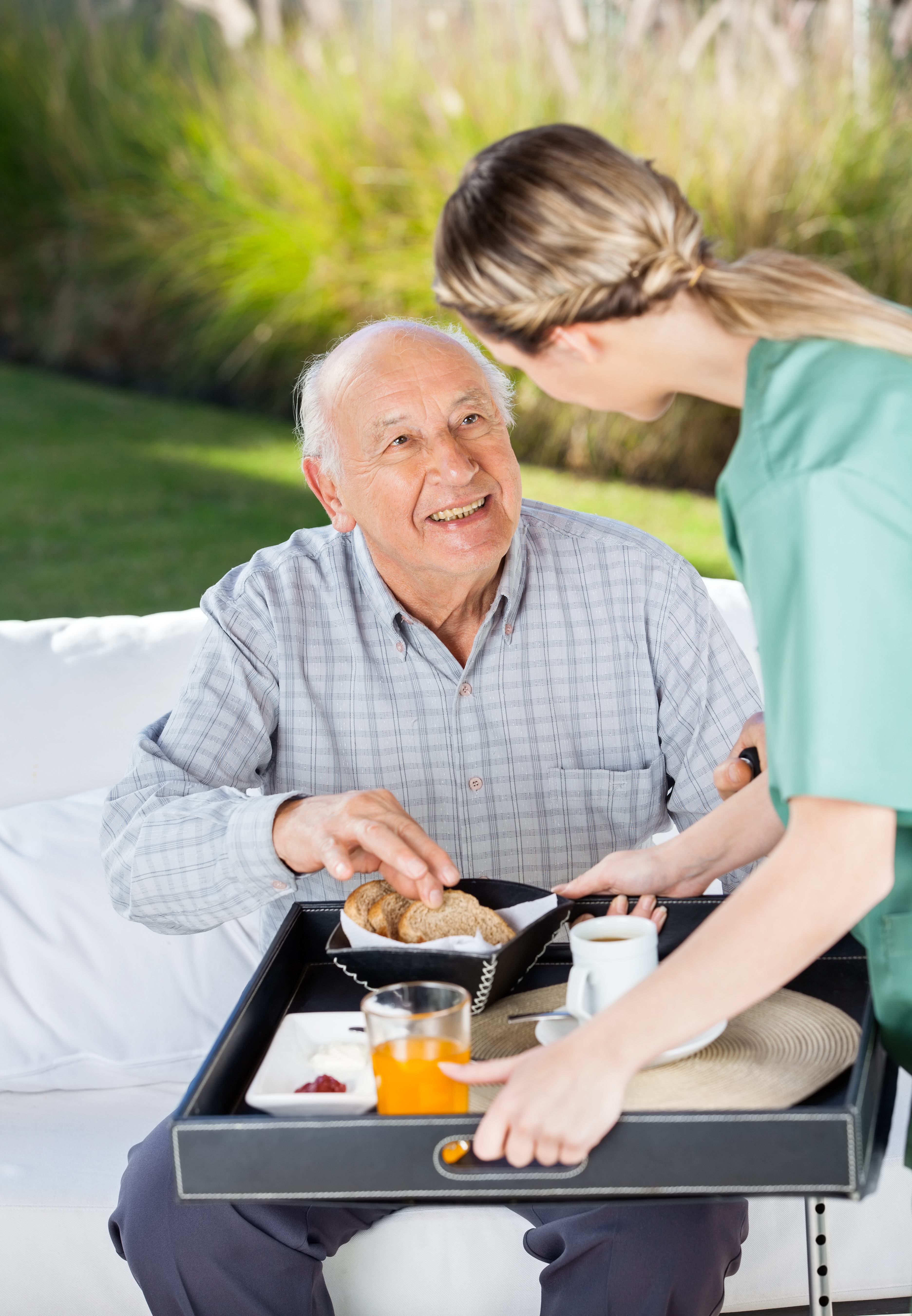 Caregiver serving elderly client
